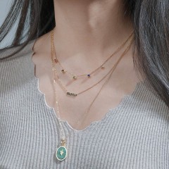 Triple layered necklace with snake pendant and color stone charm