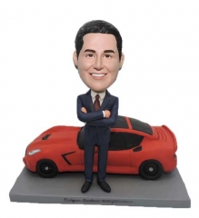 Man standing before his car bobblehead