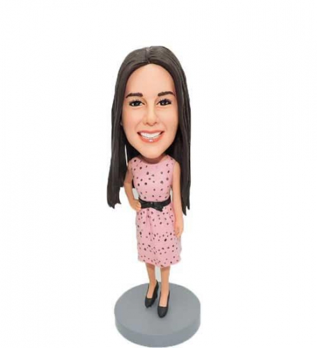 Woman bobbleheads in pink dress