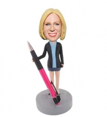 Pen holder bobbleheads on desk