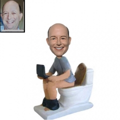 Custom bobblehead on toilet with laptop