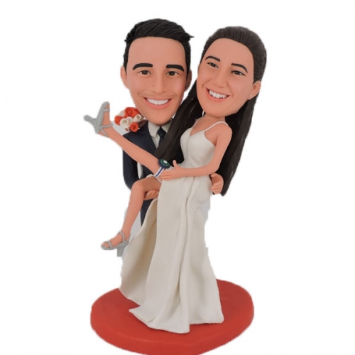 Groom carrying bride wedding cake toppers