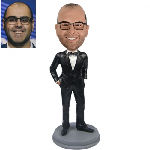 Bobble head doll with black tuxdo and bow tie