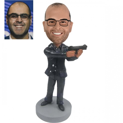 Cool bobble head doll holding gun