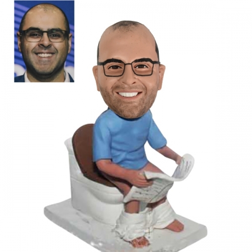 Funny bobble heads on toilet