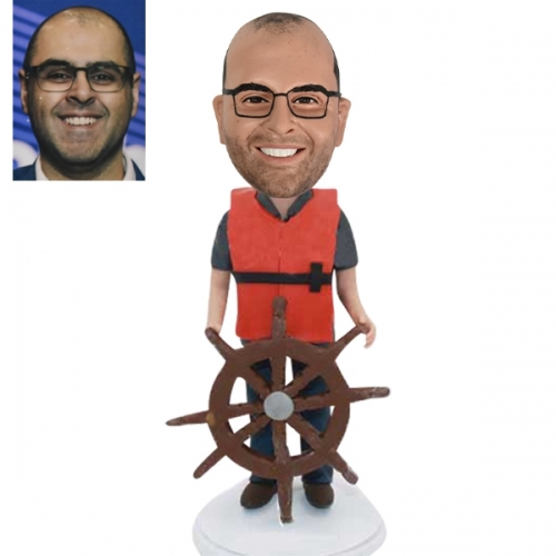 Rudder or sailor bobblehead doll