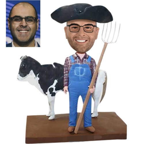 Farmer bobbleheads with cow Rancher