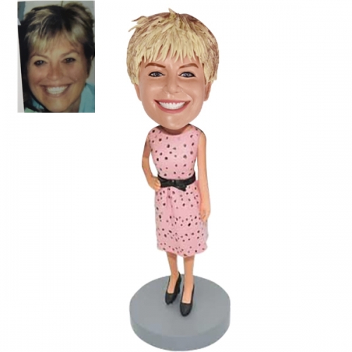 Woman bobbleheads in pink dress