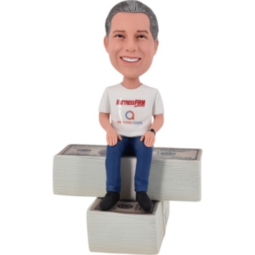 Personalized bobble head sitting on dollar money