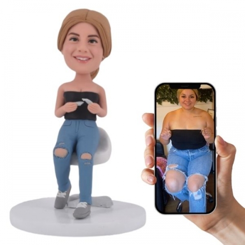 Personalized Female Bobblehead Gift Idea sitting on chair