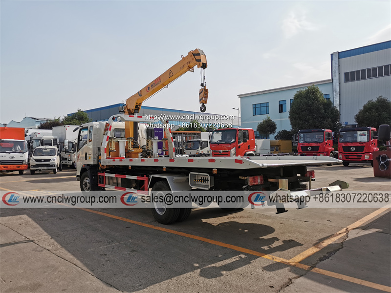HOWO RHD 5 ton tilt tray truck roll back towing a car with a truck wrecker