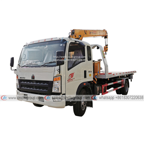 HOWO RHD 5 ton tilt tray truck roll back towing a car with a truck wrecker