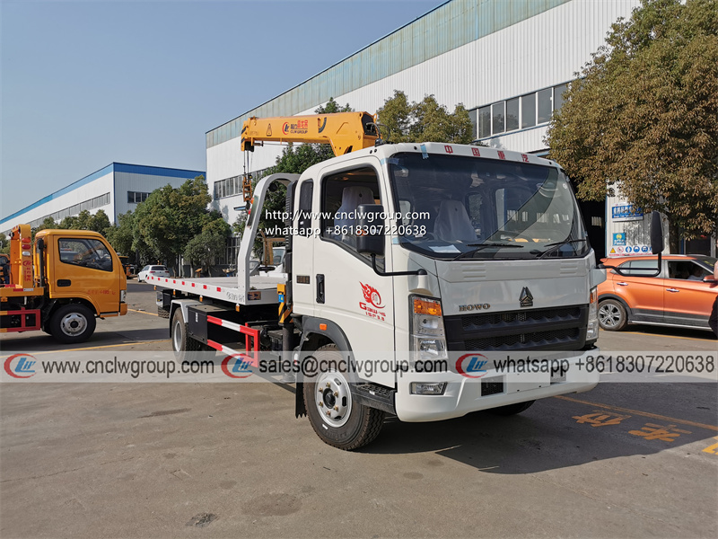 HOWO RHD 5 ton tilt tray truck roll back towing a car with a truck wrecker