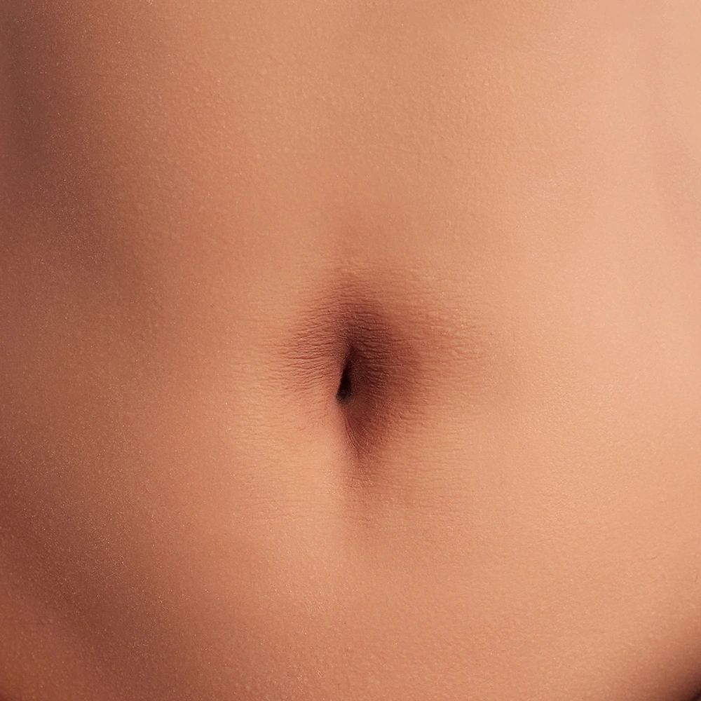 Navel close-up of Jade butt sex toy, textured skin
