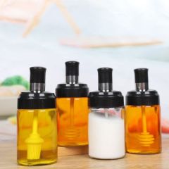 Glass bottle with Spoon, oil brush and honey spoon