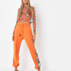 x missguided orange graphic oversized joggers