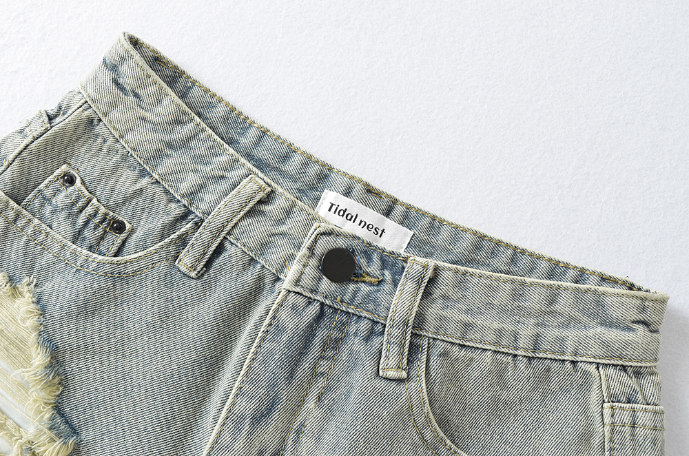 Women's burred and perforated denim shorts
