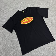 Corteiz gold and red badge tee white black