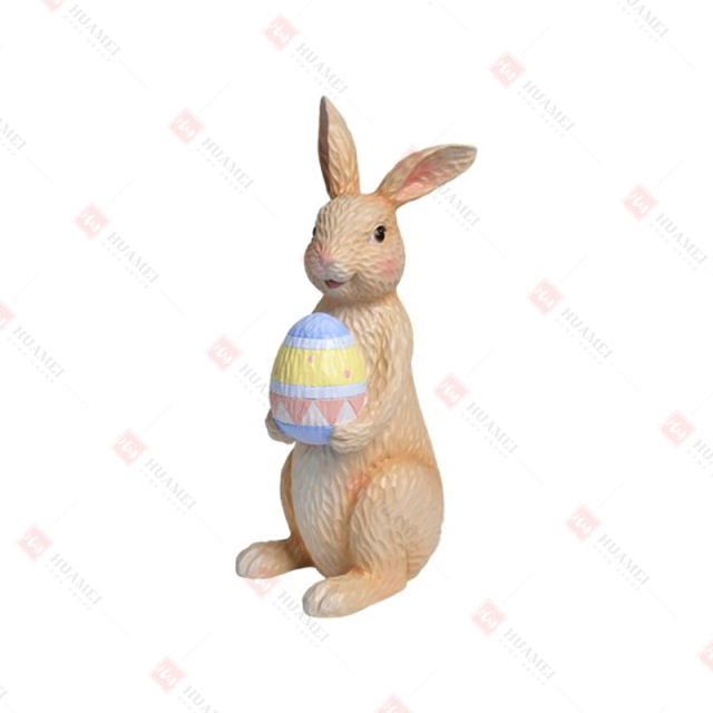 RESIN BUNNY HOLDING  AN EGG TABLE DECO