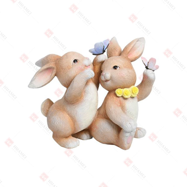 RESIN BUNNIES PLAYING WITH BUTTERFLIES