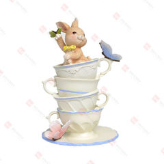 RESIN BUNNY ON STACKED CUPS