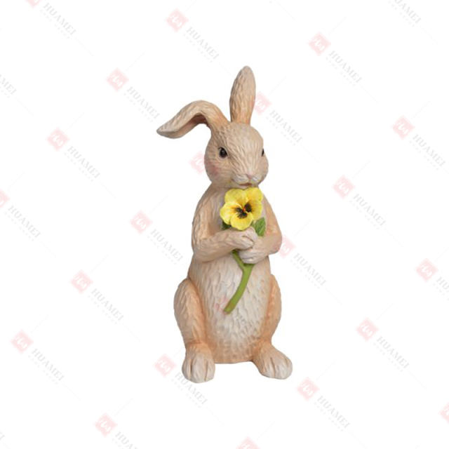 RESIN BUNNY HOLDING  A PANCY FLOWER TABLE DECO