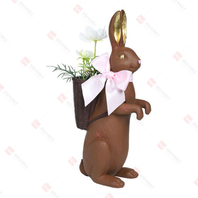 RESIN CHOCOLATE RABBIT W/
 ARTIFICIAL FLOWER IN BASKET