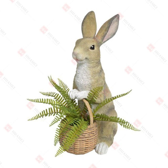 RESIN BUNNY HOLDING BASKET WITH ARTIFICIAL TAXIFOLIA INSIDE