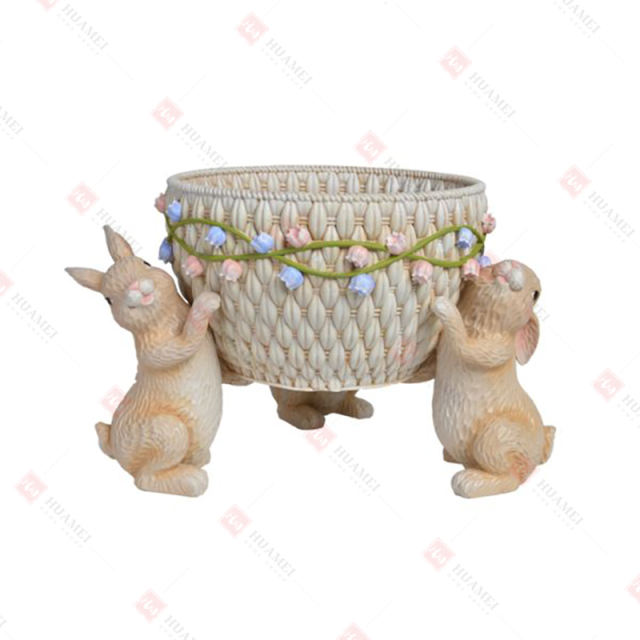 RESIN BUNNIES HOLDING
 A BASKET