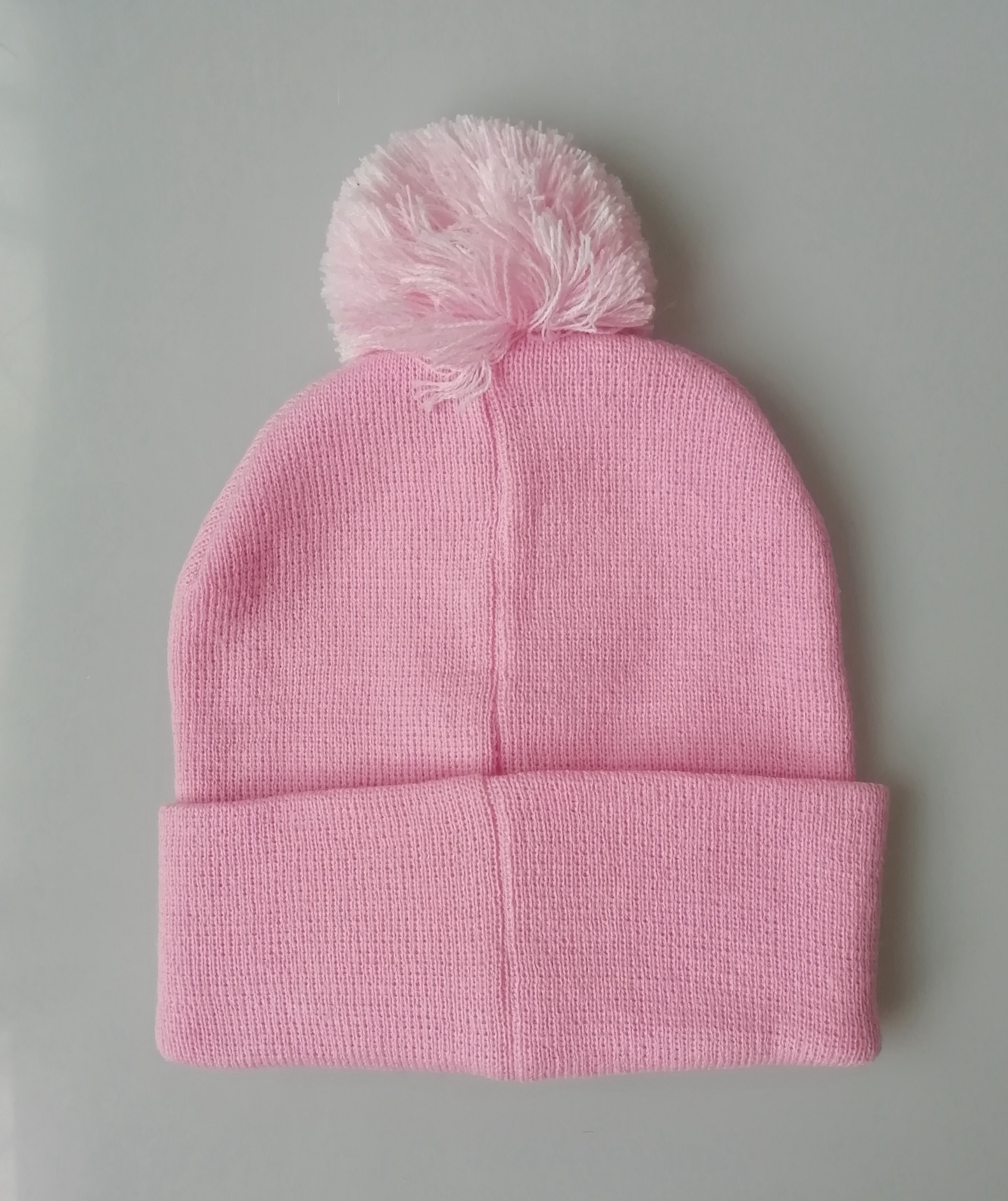 Pink bom bom beanie hat with printing label