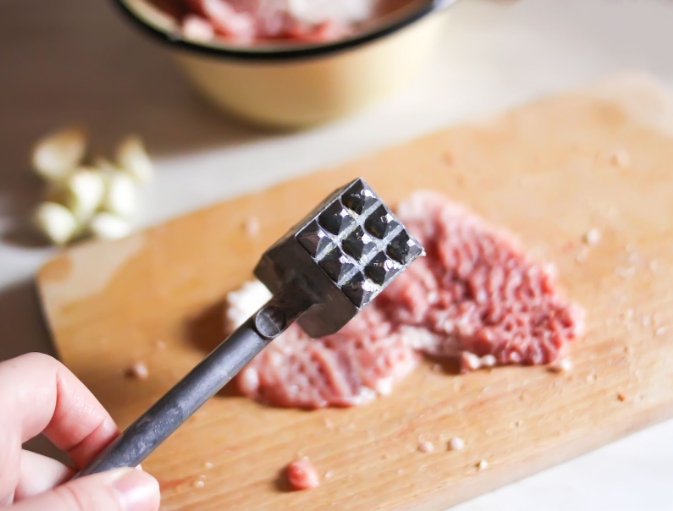A meat pounder for flattening burger patties