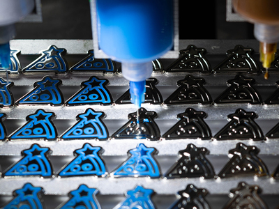 What machine is used to make enamel pins?