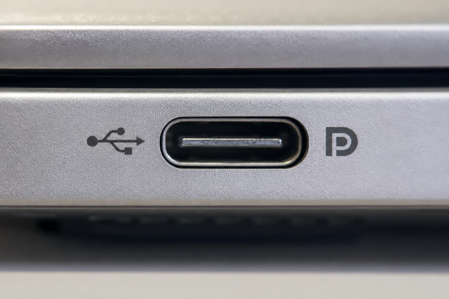 Close-up of the DisplayPort logo on the laptop's USB-C port (next to the USB symbol)