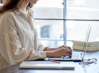 A beautiful woman is working on her laptop.