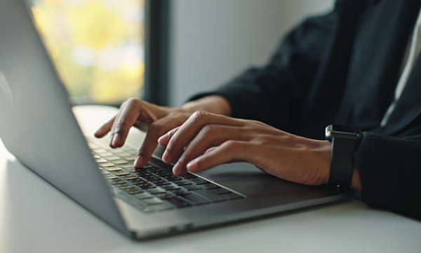 A Woman is working on a Windows computer.