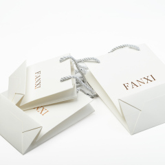 FANXI Custom Logo Packing Bags For Jewelry Watch Cloth Cosmetic Gift Shop White Coated Paper Packaging Bag