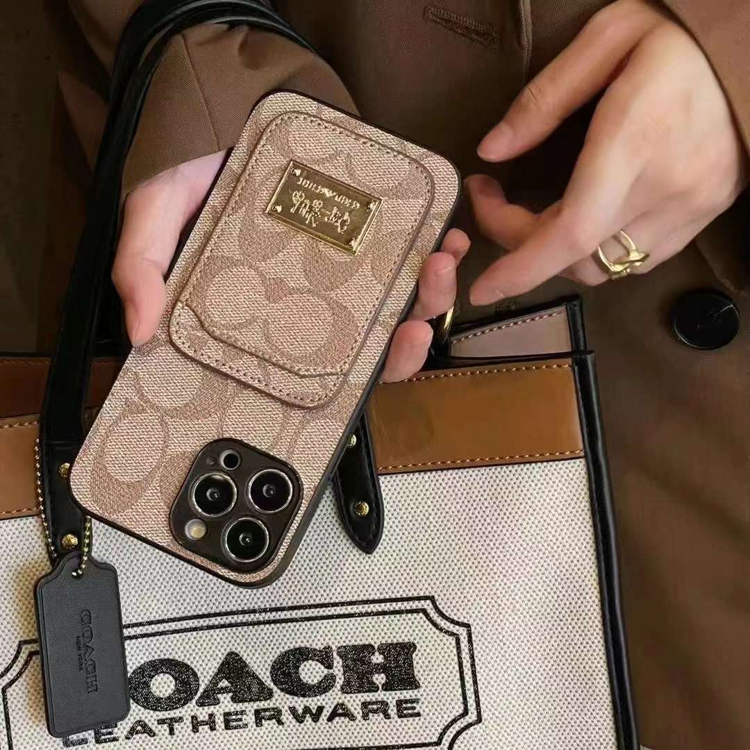 iPhone 15用 COACHブックタイプケースSIGNATURE Brown abitur