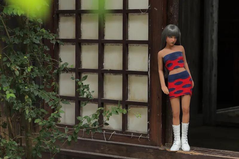 Seductive-mini-sex-doll-leaning-against-door-sakurako