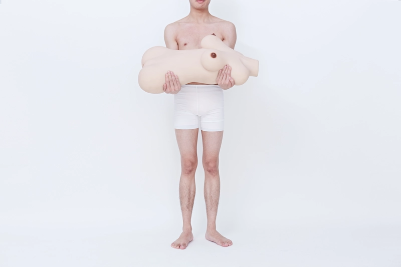 Lifelike-torso-sex-toy-round-thigh-yellow-man-holding-in-hands