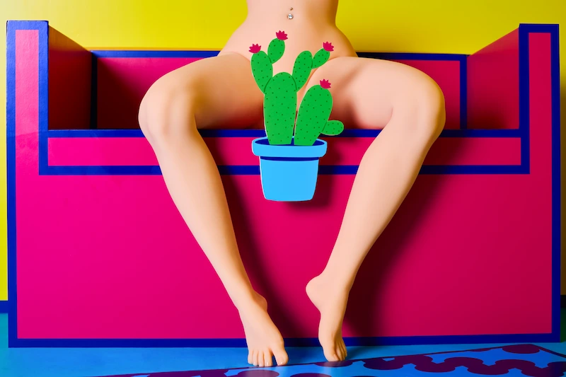 Torso-sex-toy-fat-legs-yellow-sitting-sofa-front-view