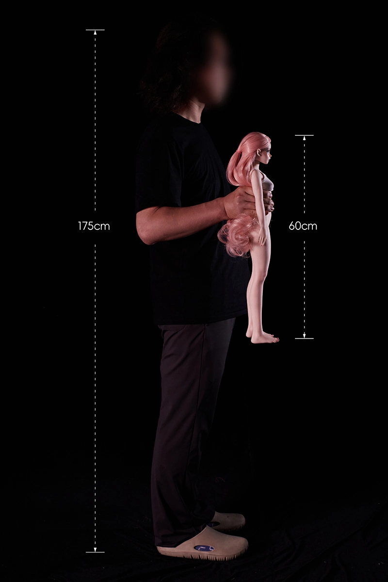 Designer-holding-silicone-mini-sex-doll-side-view-demonstration