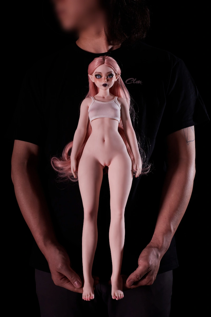 Product-designers-hands-holding-silicone-mini-sex-doll-close-up-front-view
