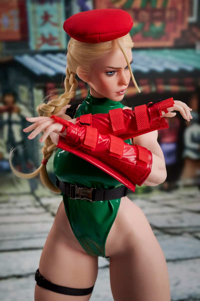 CLM Si70 KA Freya 70cm silicone sex doll in a green bodysuit, arms crossed in defense with a cool side-glance. A lightweight and compact anime doll.