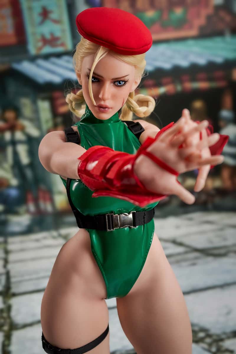 CLM Si70 KA Freya 70cm silicone sex doll standing with fingers elegantly interlaced. A graceful, lightweight sex doll and compact anime doll in a green bodysuit.