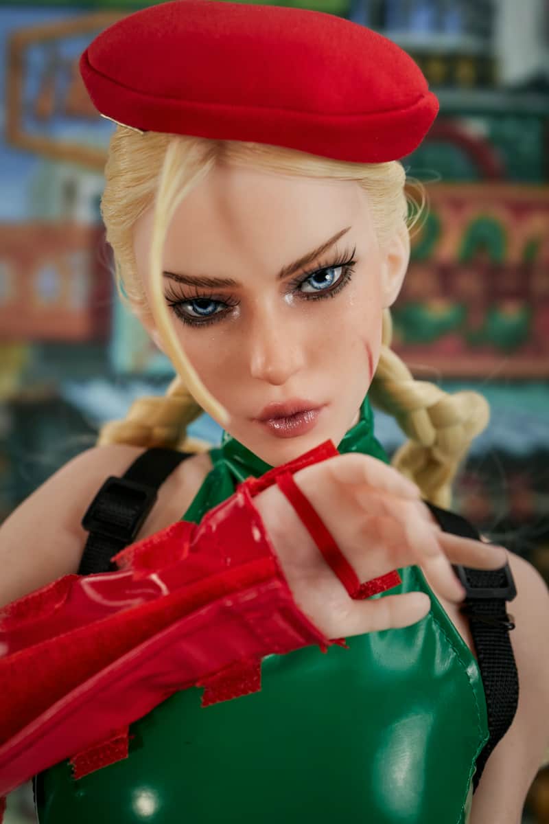 In a striking facial close-up, this **anime sex doll**, Si70 KA Freya, features exquisite blue eyes and a bold, heroic makeup look. The red battle-worn scars on her face, paired with a cool, stoic expression, perfectly capture the intricate details of a warrior's resolve and seductive charm.