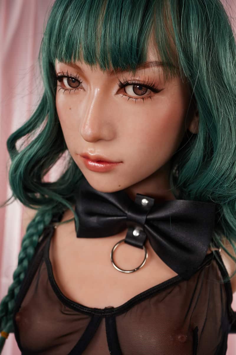 ULW 881# Mayu: This front close-up highlights the doll with dark green wavy hair and straight bangs, featuring delicate makeup with glossy coral lips and a black bow choker, dressed in a sheer black lace bralette.