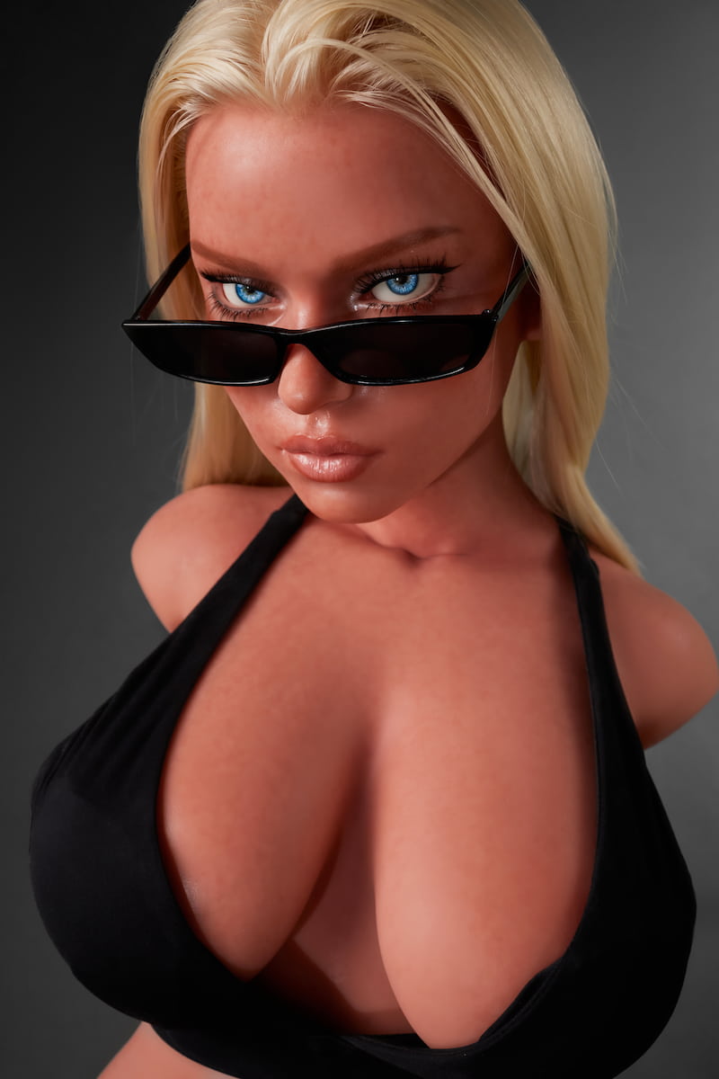 ULW 883# Fiora: This close-up features a blonde head sculpt with sophisticated Western-style makeup, highlighting exceptionally voluminous, firm breasts and realistic skin textures beneath a partially lifted black top.