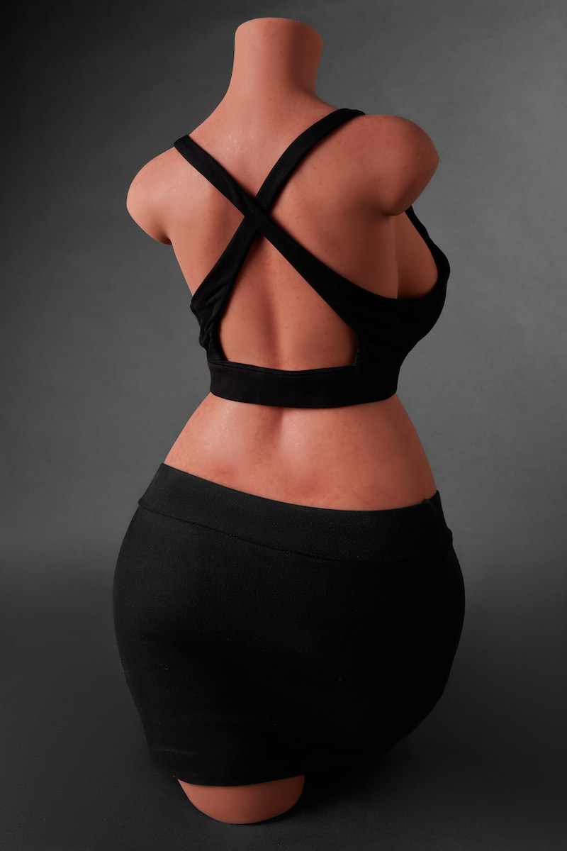 ULW 883# Fiora: This rear-view mid-shot highlights a headless half-body torso in a black cross-strap top, emphasizing rounded back lines and a firm side-bust profile, with healthy skin detailed by realistic freckles.