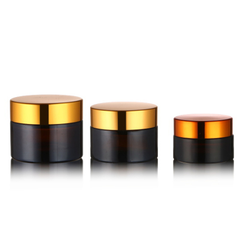 Amber brown cosmetic glass cream jar with gold cap lid