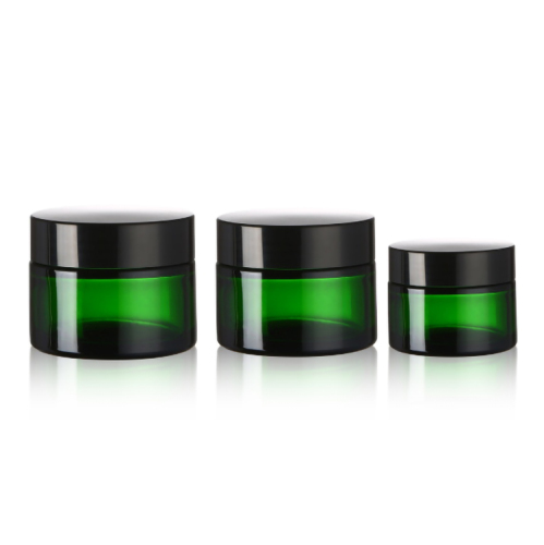Empty green eye face cream cosmetic glass jar with black cap lid